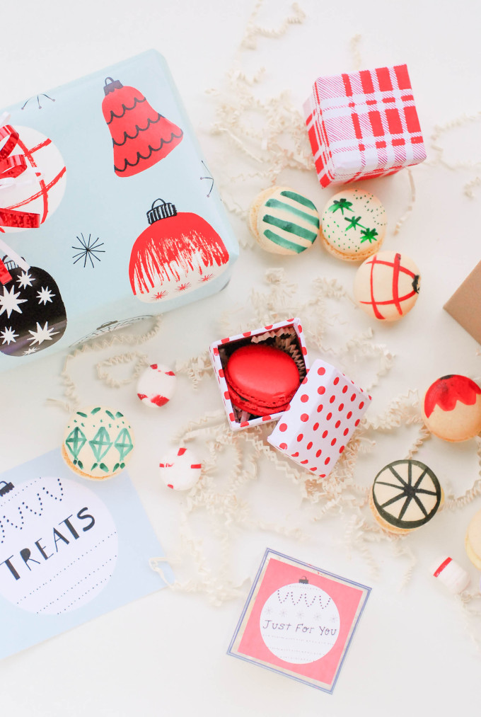 holiday printables and decorated macaron cookies on flatlay with ornaments