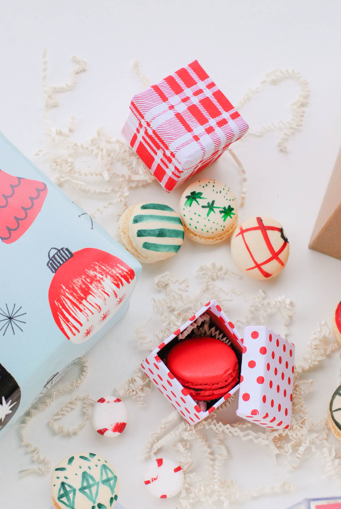 holiday printables on flatlay with decorated macaron cookies and ornaments