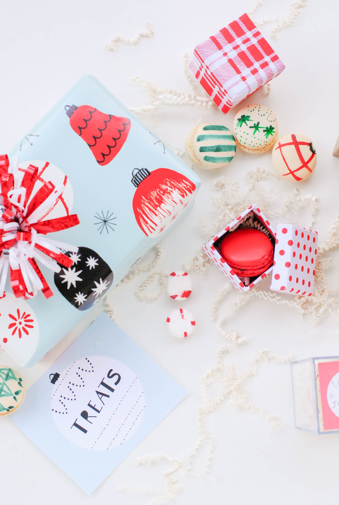 holiday printables on flatlay with decorated macaron cookies and ornaments