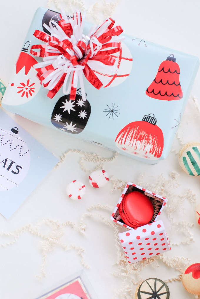 holiday printables on flatlay with decorated macaron cookies and ornaments