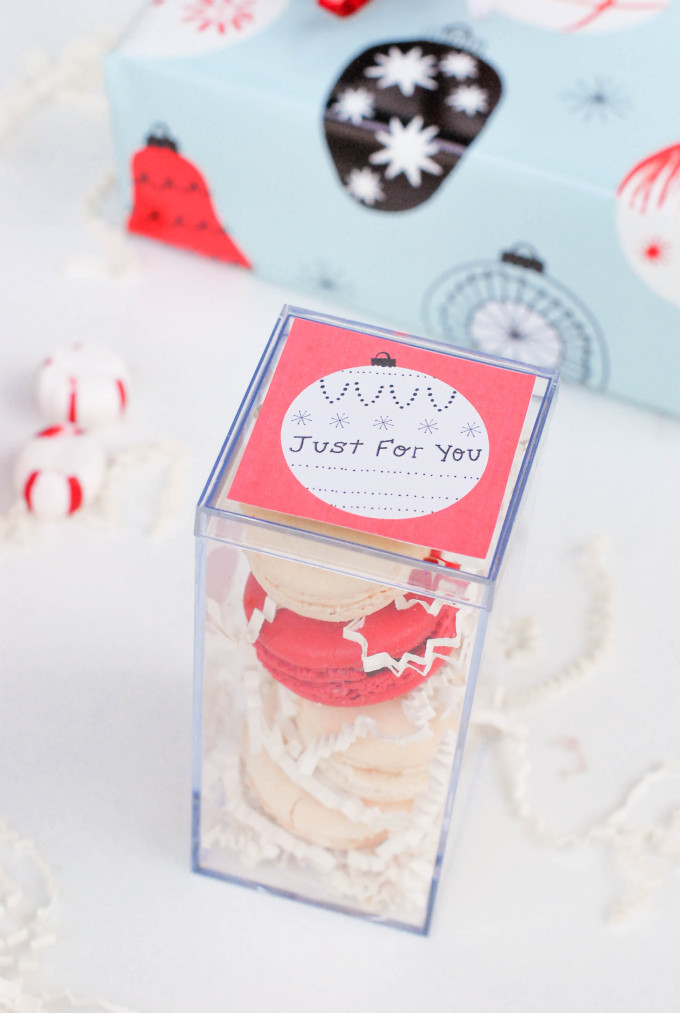 holiday printables on flatlay with decorated macaron cookies and ornaments