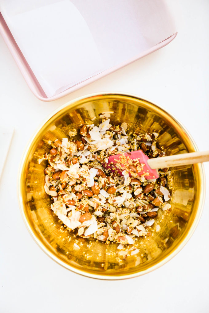 granola bar ingredients in gold mixing bowl