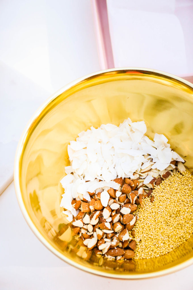 granola bar ingredients in gold mixing bowl