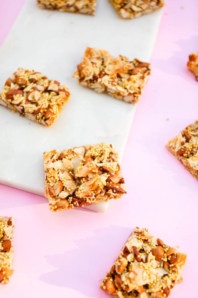 almond and coconut granola bars sitting on slab of marble