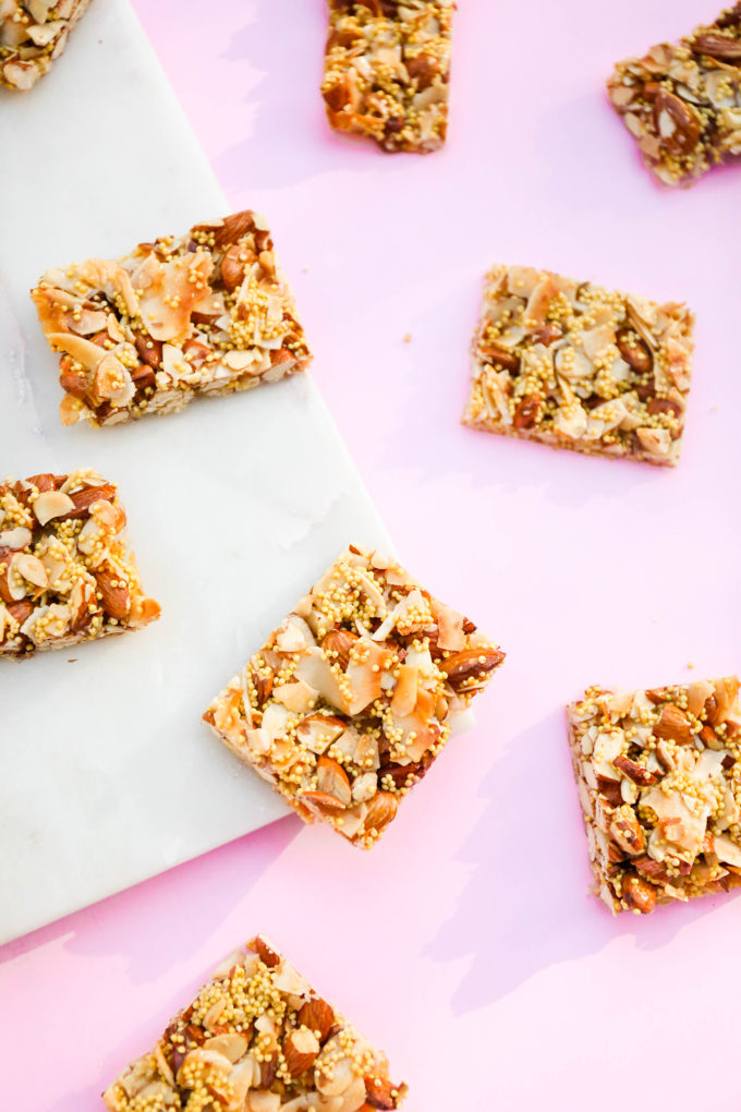 closeup of homemade granola bars sitting on pink and marble slab