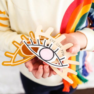 DIY wooden valentines held in the hands of a little girl