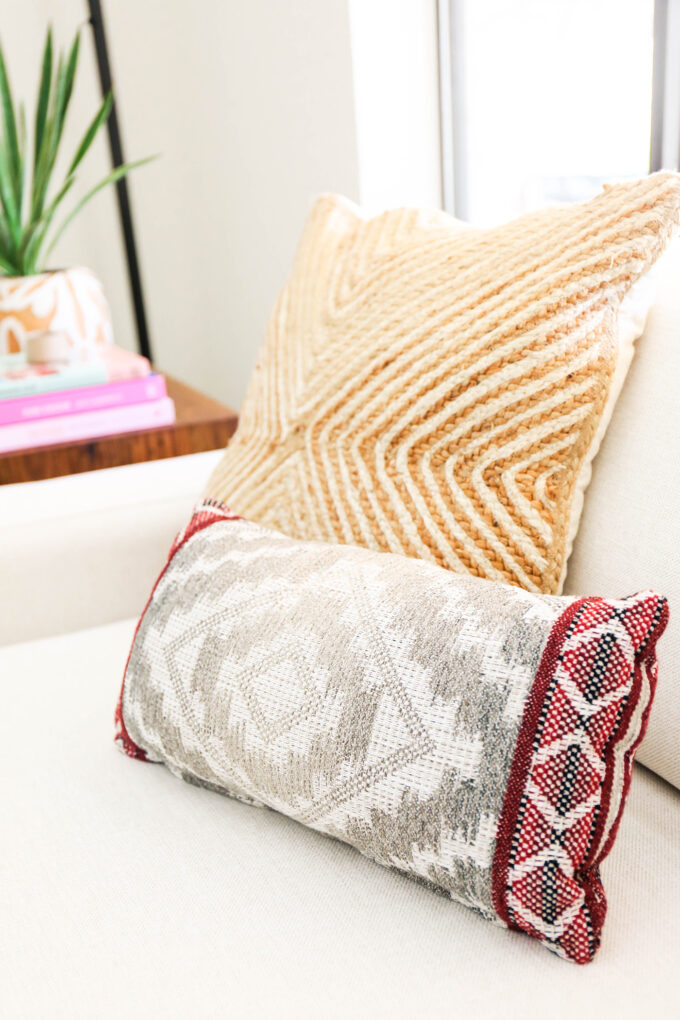 close up of pillows on white chair 