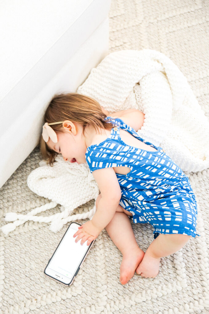 baby snuggling soft blanket on cozy rug 