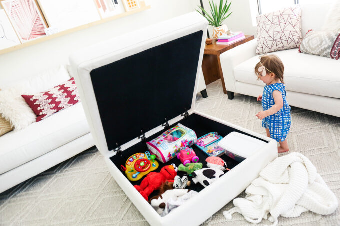 baby surprised by hidden toy storage in furniture 