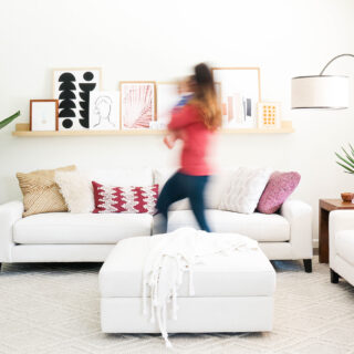 blurred woman walking in front of modern furniture