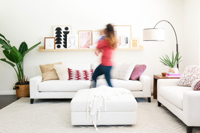 blurred woman walking in front of modern furniture