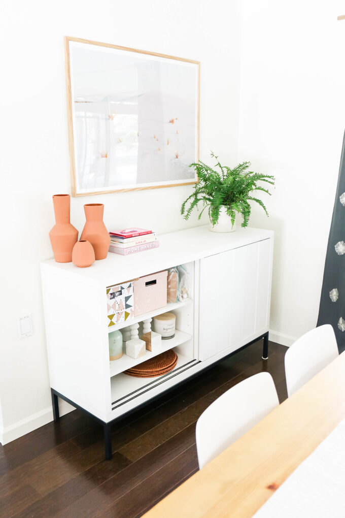 dining room setup with sideboard, table, and curtains