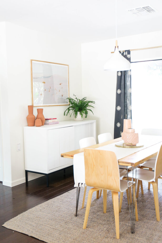 dining room setup with sideboard, table, and curtains