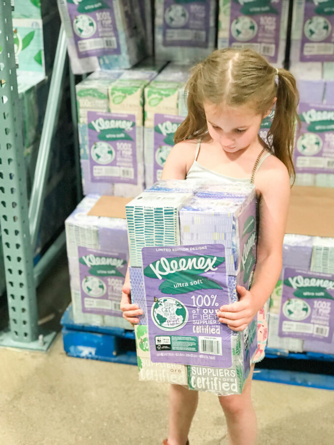 little girl holding kleenex tissues at costco