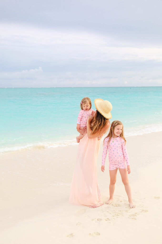 mom and two daughters on beach 