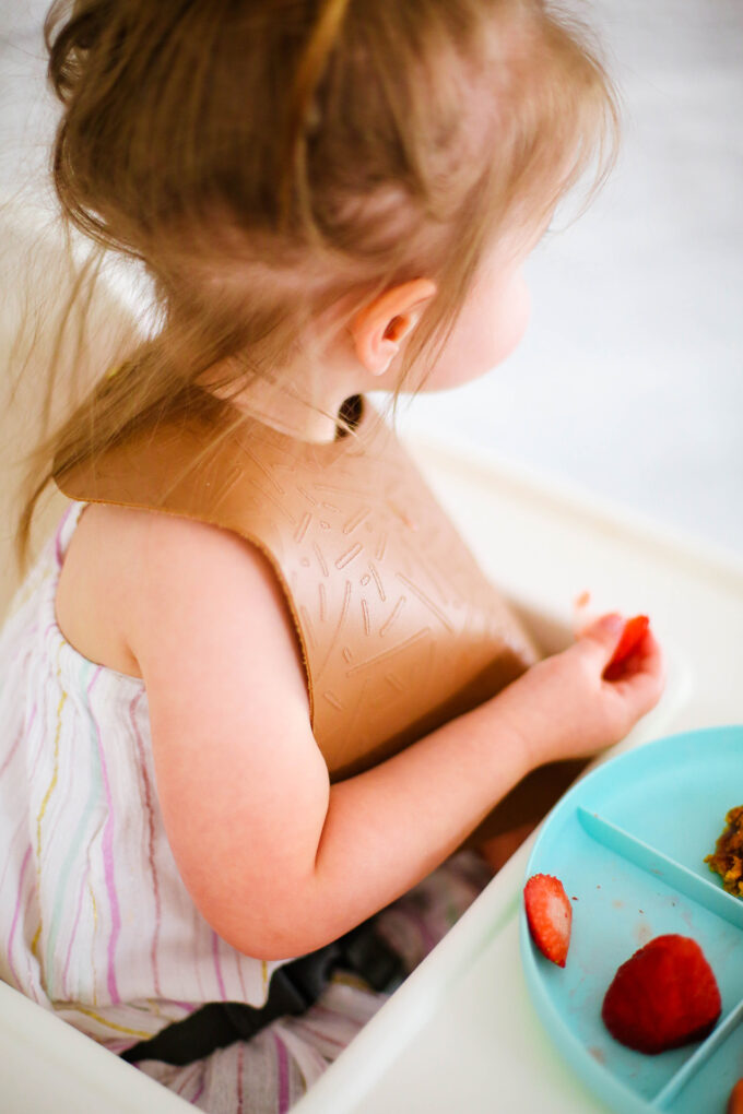 baby wearing leather bib