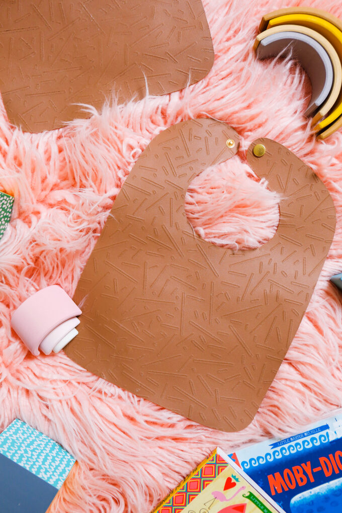 DIY leather bib flatly on pink background 