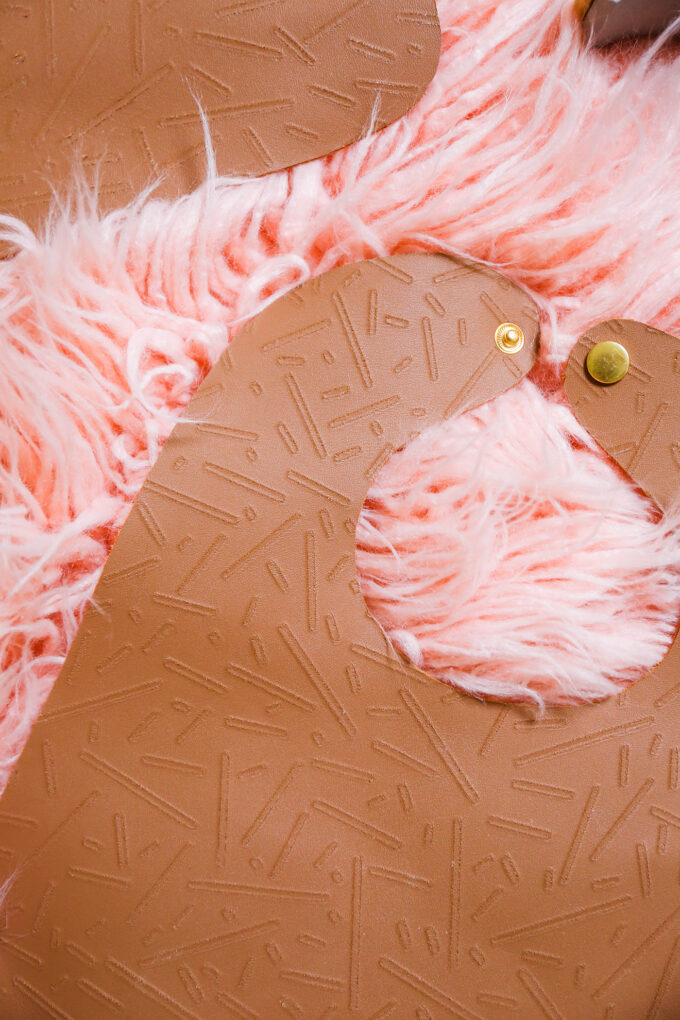 DIY leather bib flatly on pink background 