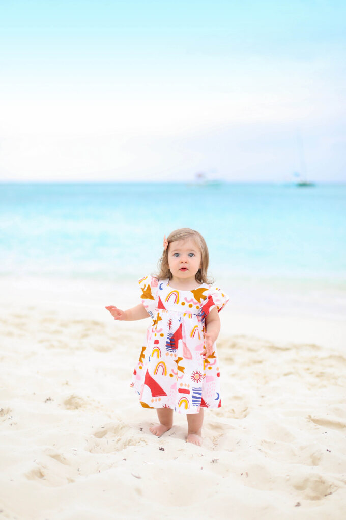 baby walking on beach