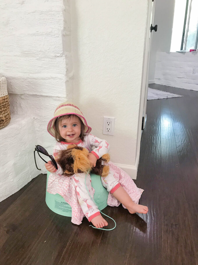 toddler sitting in bumbo chair