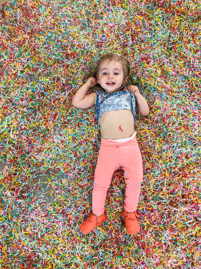 baby laying in confetti