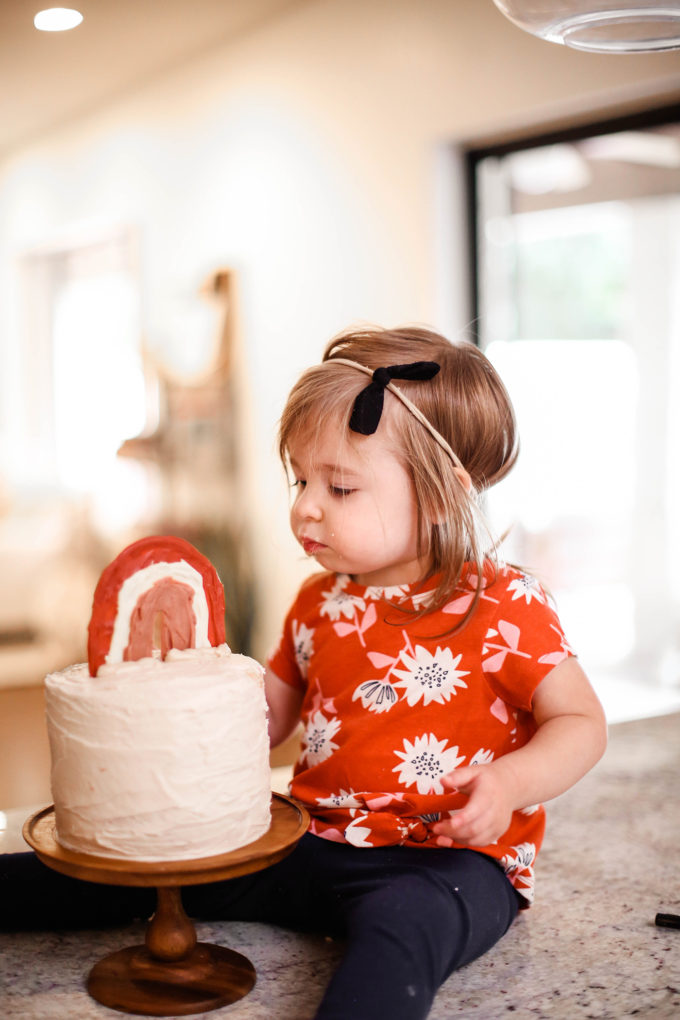 little girl staring at birthday cake 