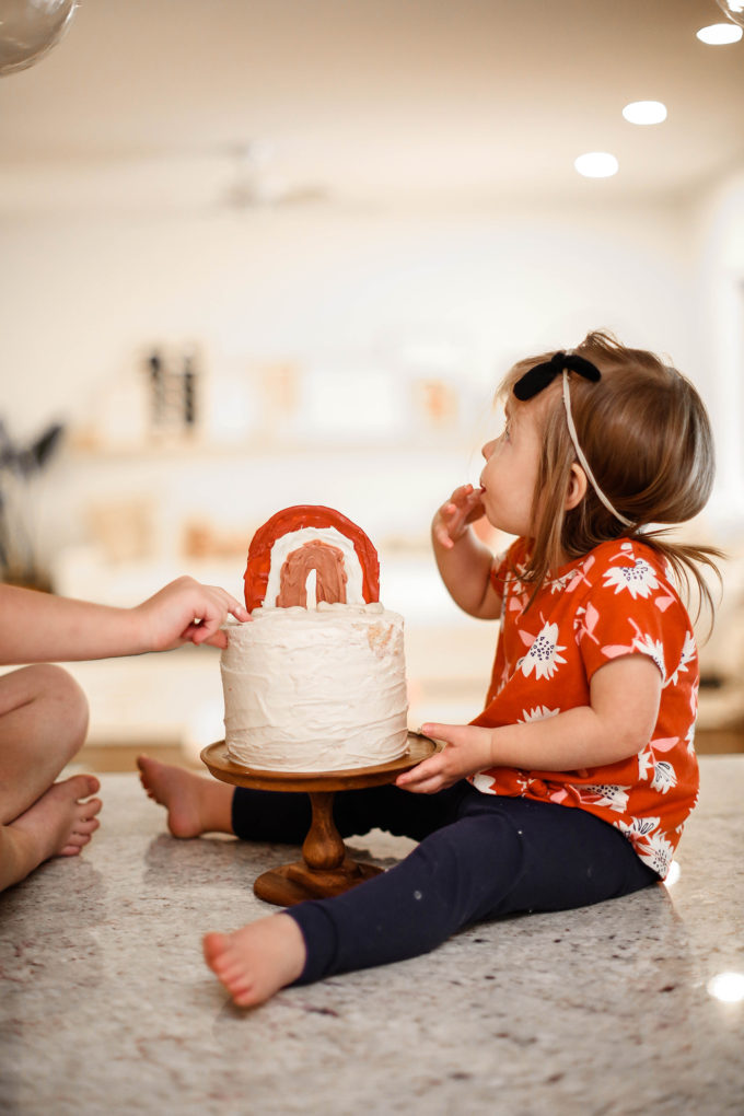 little girl eating birthday cake 