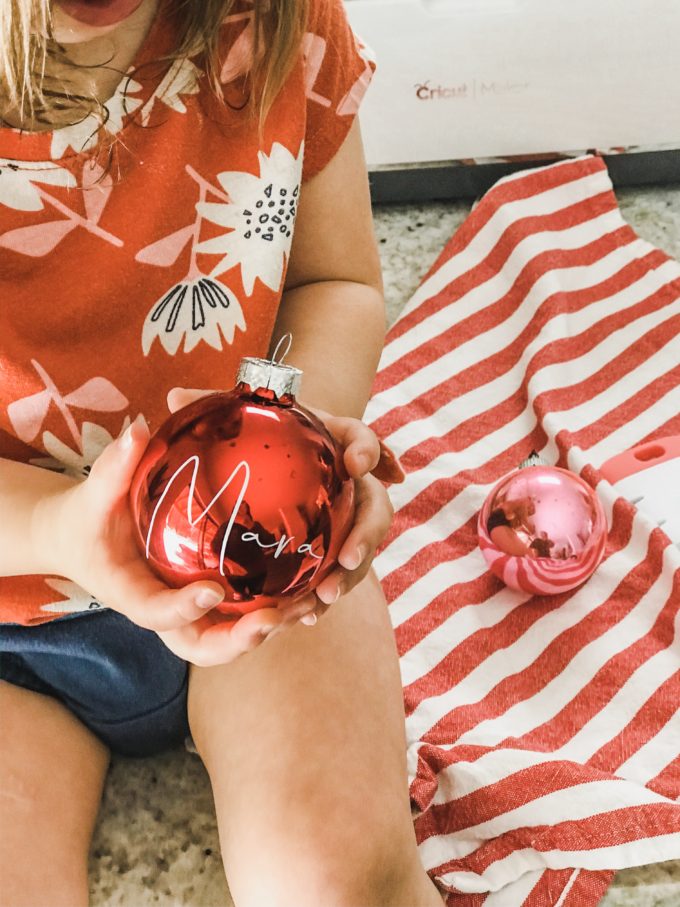 little toddler holding personalized christmas tree ornament 