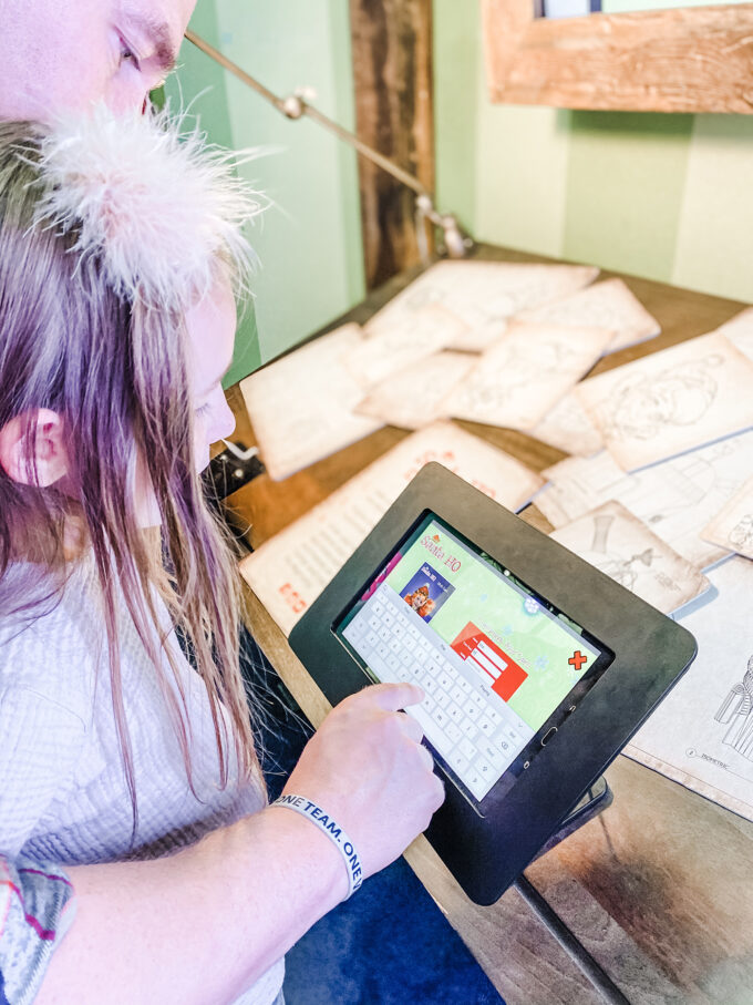 little girl using tablet to make herself look like santa's elf 