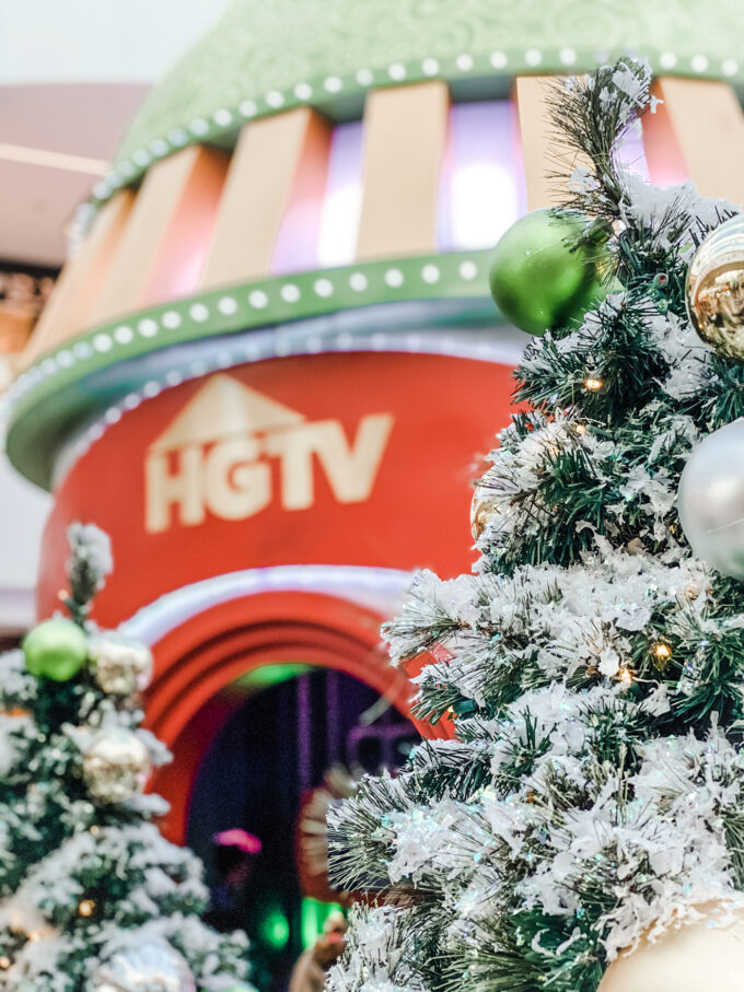 HGTV santa hq sign behind a christmas tree closeup 