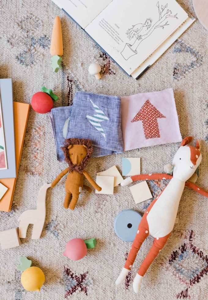 colorful kid toys scattered on floor 