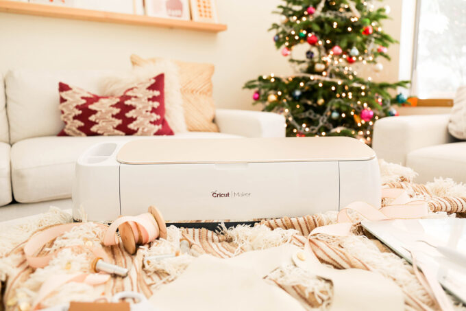 cricut maker and tools styled in front of christmas tree