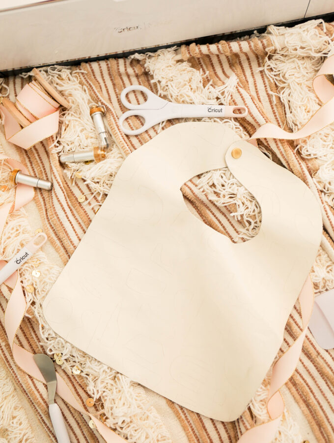 leather bib scattered on blanket with cricut tools
