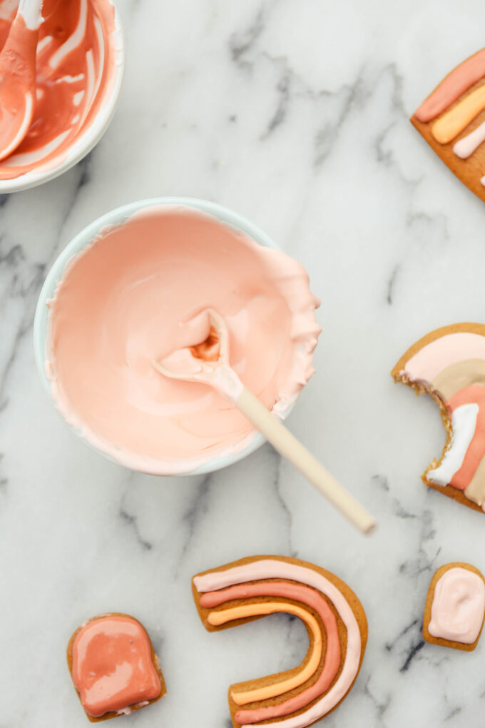 closeup of pink tinted royal icing in bowl 