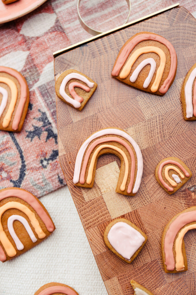 Boho Rainbow Gingerbread Cookies scattered on cutting board 
