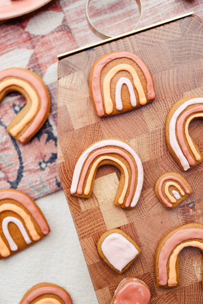 Boho Rainbow Gingerbread Cookies scattered on cutting board 