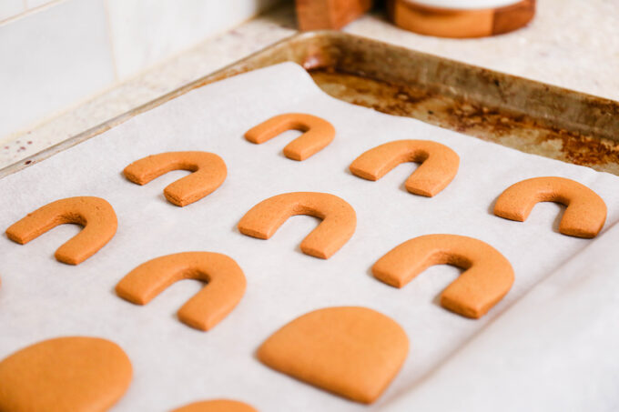 gingerbread cookie cutouts cooling on sheet 