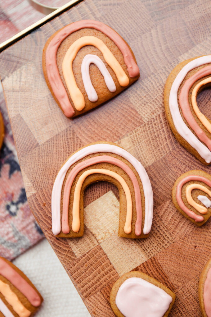 closeup of Boho Rainbow Gingerbread Cookies on wooden cutting board 