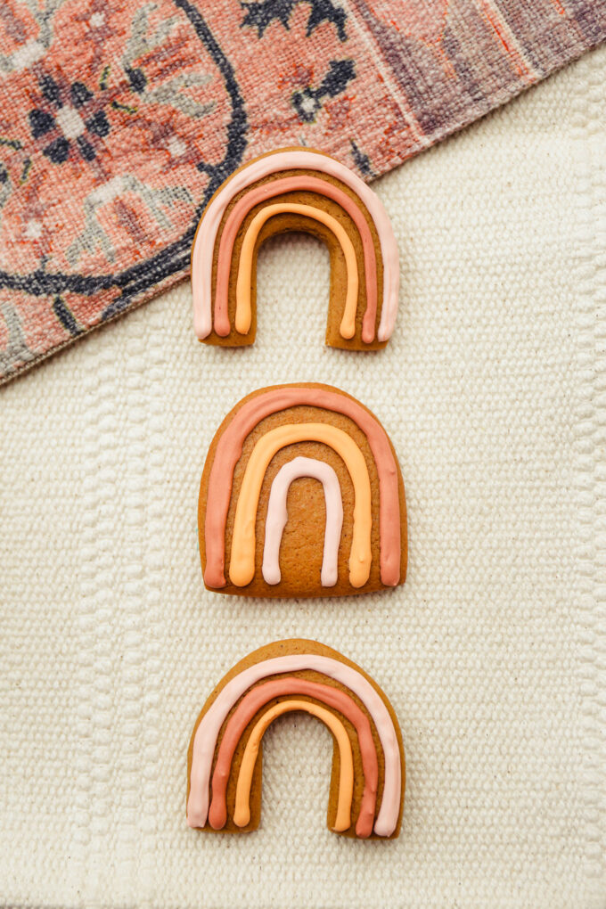 three Boho Rainbow Gingerbread Cookies stacked in a row 