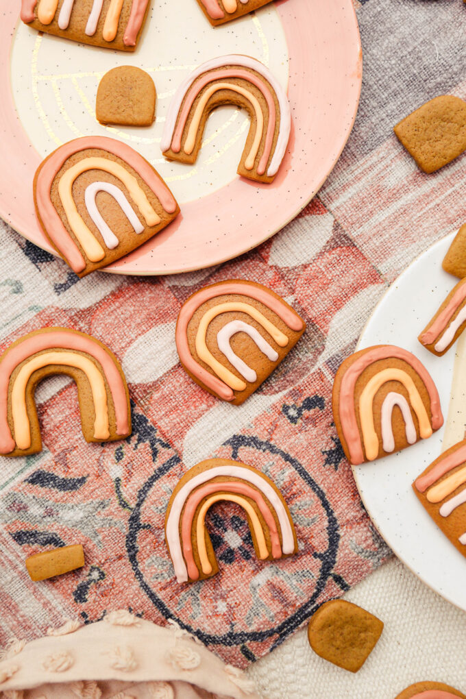 Boho Rainbow Gingerbread Cookies scattered on fabric and plates 