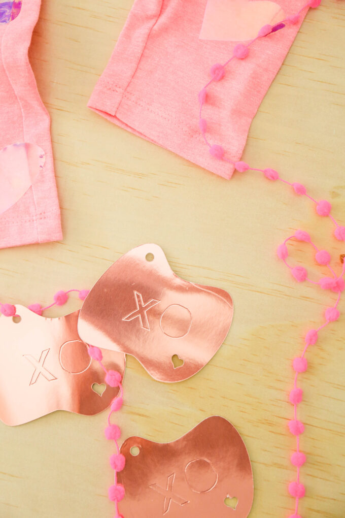 valentine's day items in flatlay with pink ribbon