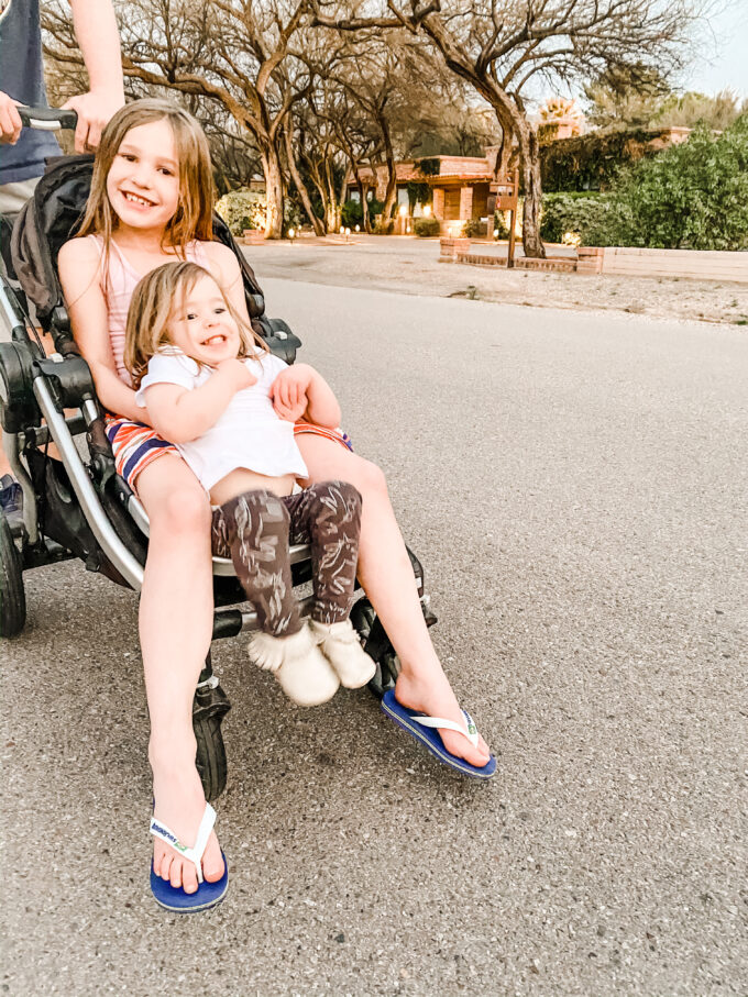 sisters sitting together in stroller 