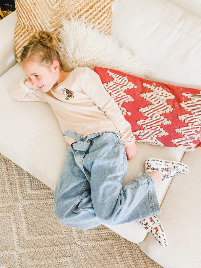 little girl laying on couch