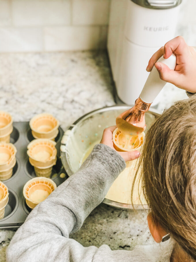 Funfetti Cupcake Cones - little girl pouring batter into cone