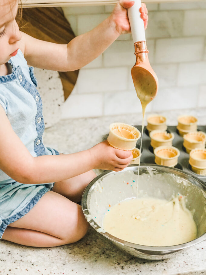 Funfetti Cupcake Cones - little girl pouring batter into cone