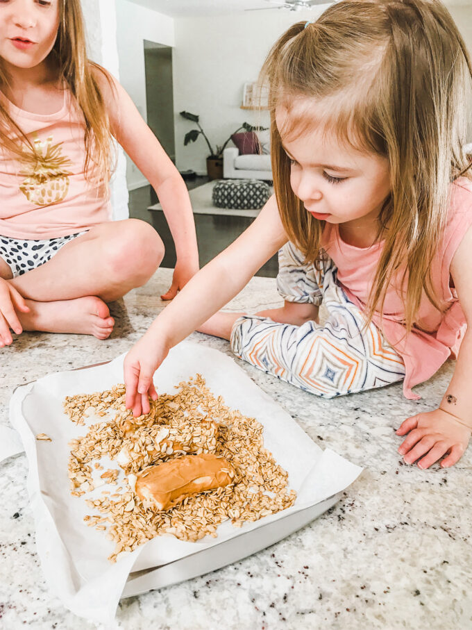 little girls making banana sushi 