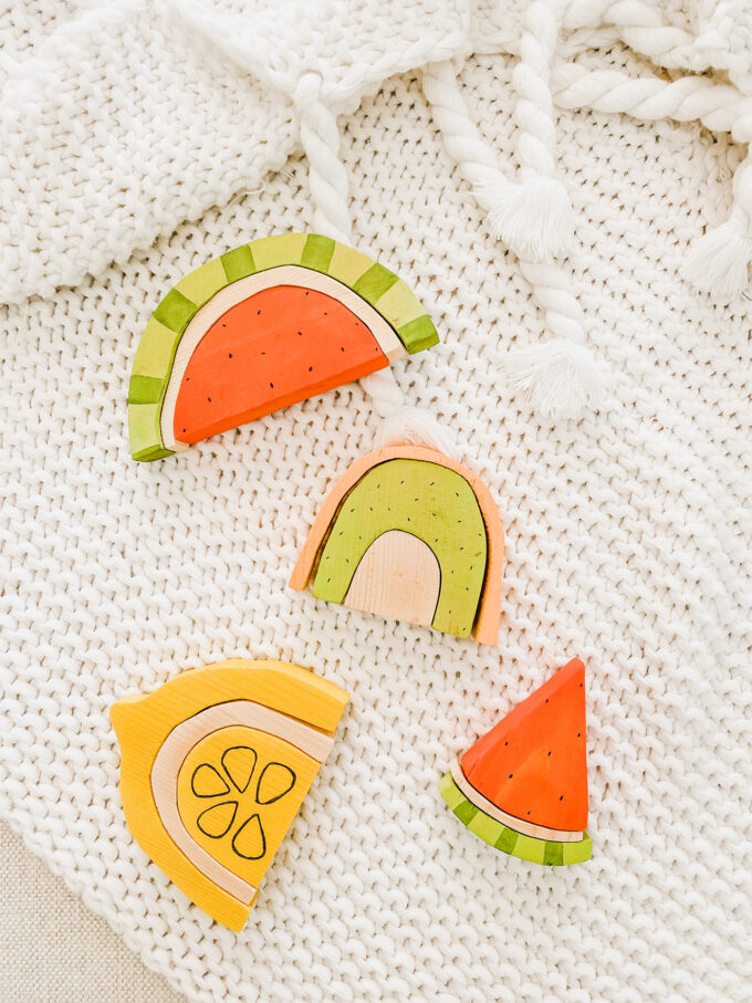 DIY Wooden Fruit Stacking Toys spread out on blanket