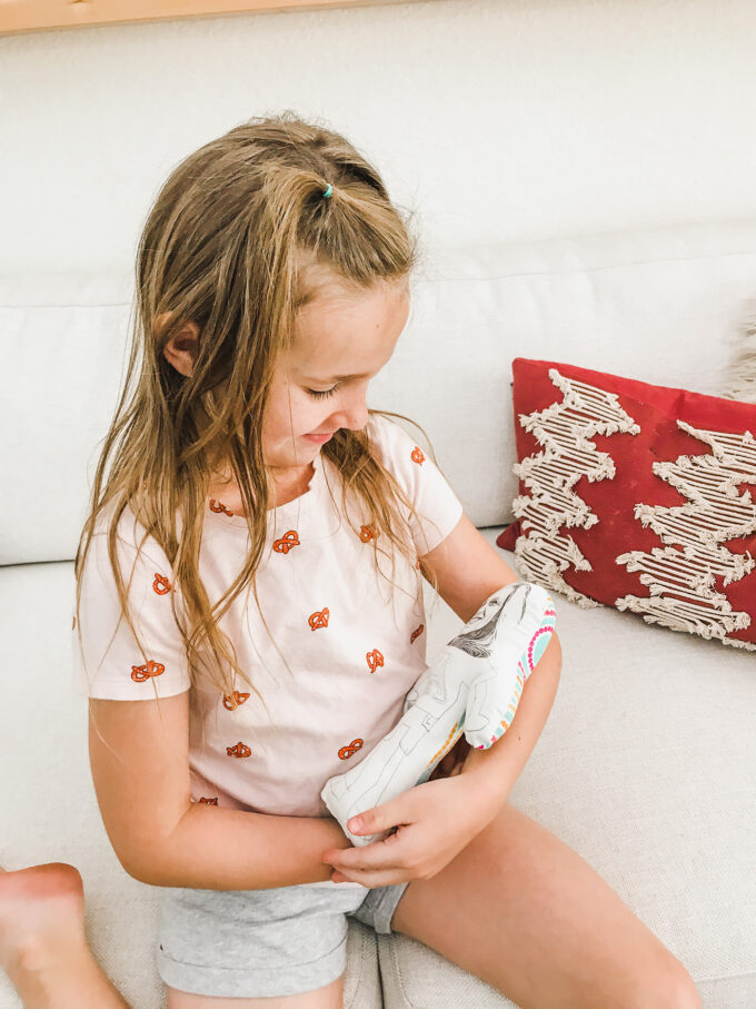 little girl holding homemade doll 